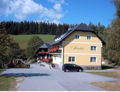 Dirndlhof, © Dirndlhof Gelbes Gebäude mit der Aufschrift 'Dirndlhof' in ländlicher Umgebung.